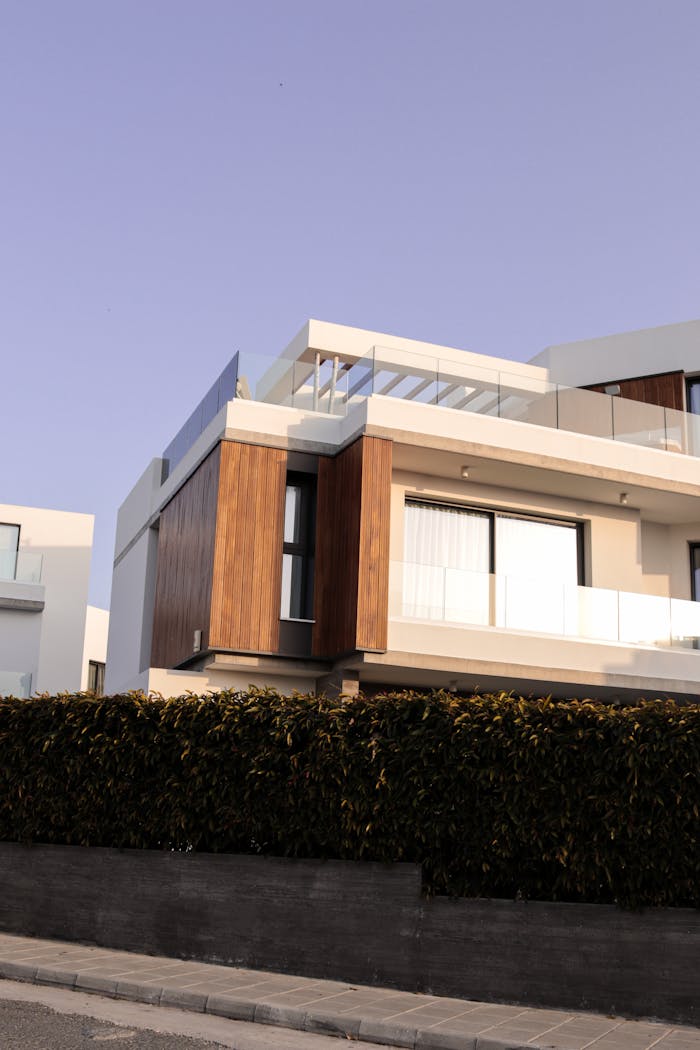 Contemporary white and wooden villa exterior shot at daytime with elegant design.